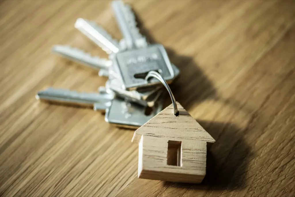 Homeowner receiving cash buyer keys as an alternative to traditional home selling